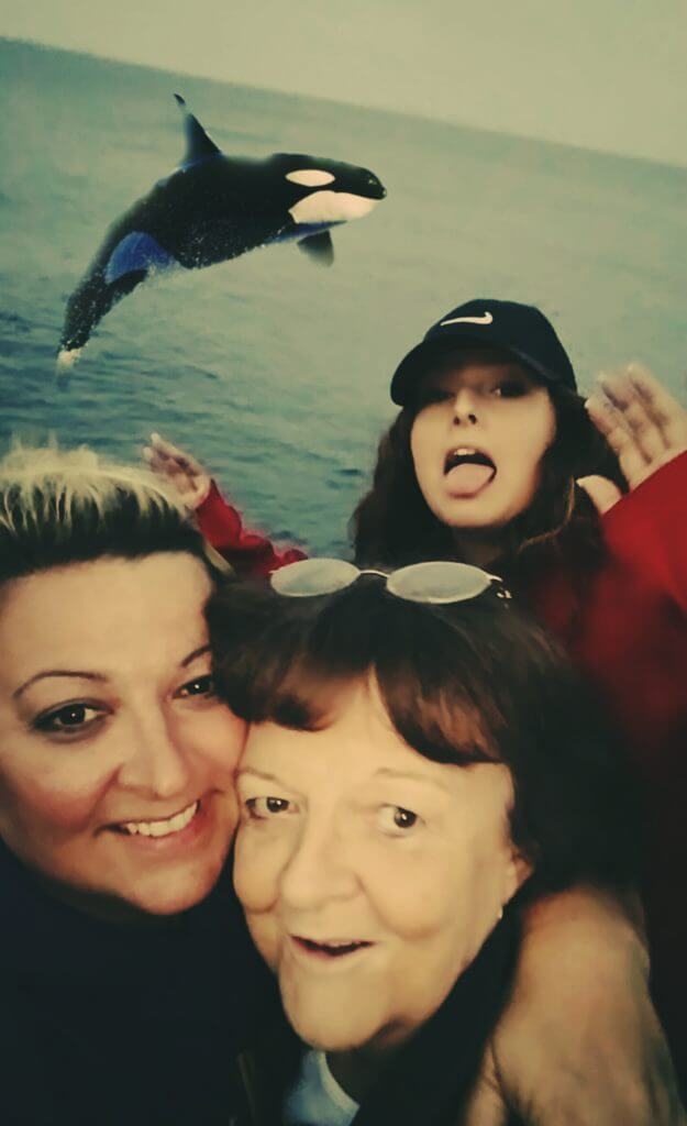 three generations of women from iowa pose with a leaping whale lake superior