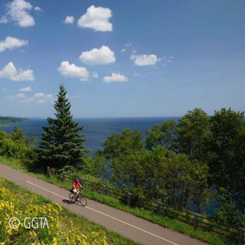 ggta-bike-trail bike rider on gitch gami bike trail along shore of Lake Superior between gooseberry falls and split rock lighthouose
