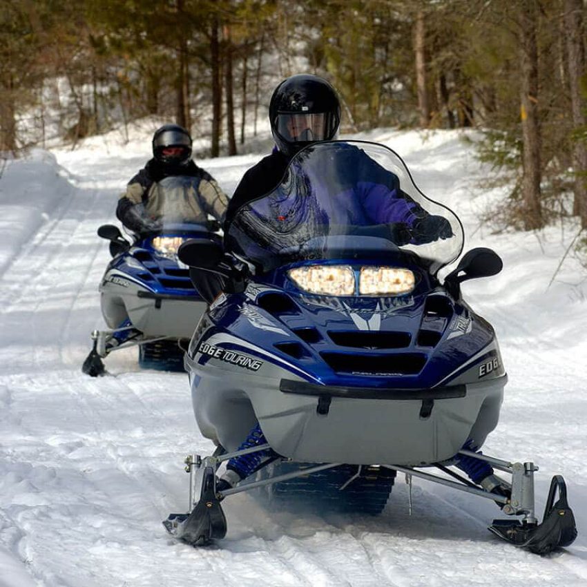 misc-visit-other-attractions-9721-image close up of two snowmobilers coming down a trail in grand portage